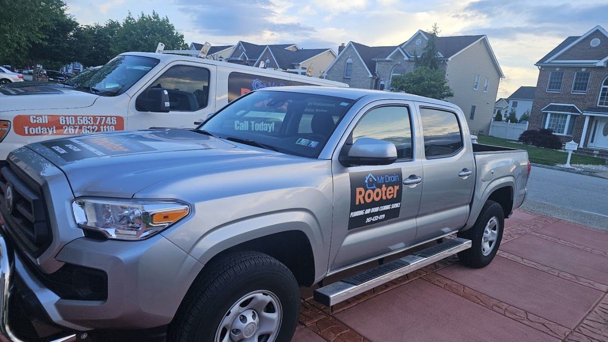 Mr Drain Rooter service trucks parked on a residential street