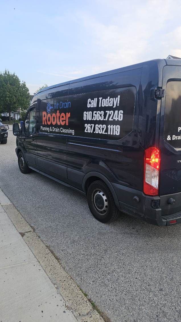 Black Mr Drain Rooter van on a Philadelphia street